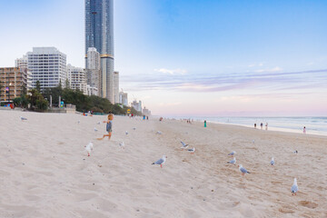 Little boy running along the sand on Gold Coast beach