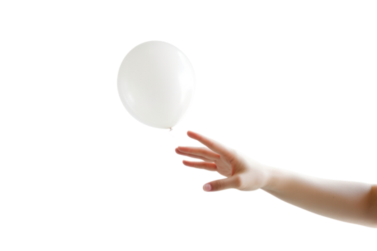 A tranquil moment captured as a hand opens to let a white balloon float away, with the sun illuminating the balloon's surface