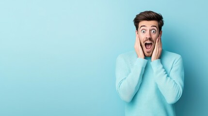 Surprised Young Man Expressing Emotions Against a Bright Blue Background in a Cozy Sweater