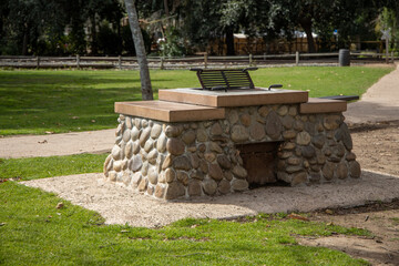 Fototapeta premium Outdoor barbecue grill and island made of stone and cement at a park.