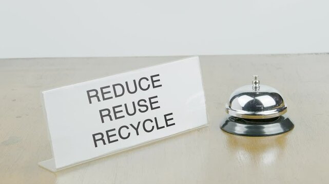 Reduce Reuse Recycle Office or Room with Hand Ringing The Bell on Desk or Table Multiple Times