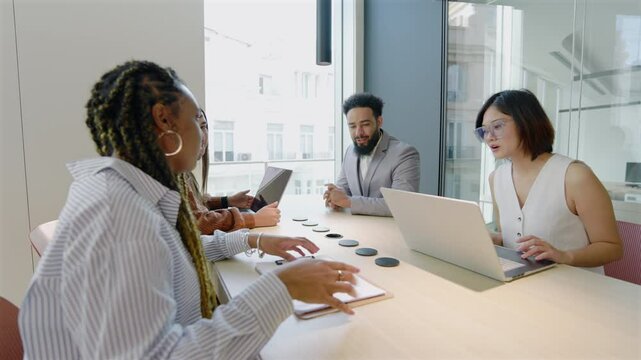 A skilled, diverse group of business professionals collaborates innovatively, showcasing teamwork and ideas in a modern office, highlighting the essence of corporate success in todays business world