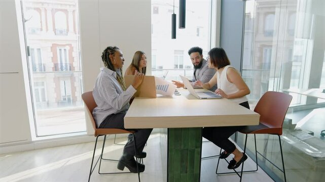 Diverse group of skilled professionals coming together in a collaborative meeting within a modern office environment, actively showcasing their commitment to teamwork, creativity, and innovation