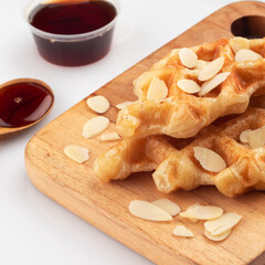 A fusion of croissant and waffle, called croffle, with chocolate sauce, almond crumble and...