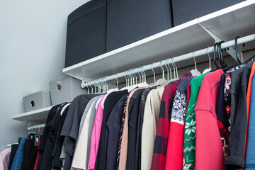 Organized wardrobe with cloths and rack boxes on top