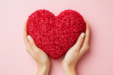 Obraz premium Hands holding a red heart isolated