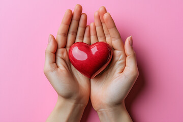 Fototapeta premium Hands holding a red heart isolated