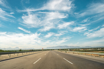 Three lane highway going forward on a sunny day