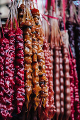 Churchkhelas, a traditional Georgian treat made from hazelnuts and grape juice, hanging at Dezerter bazaar, a market in Tbilisi, Georgia
