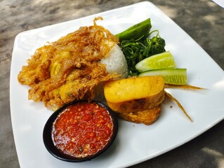 Rice and fried egg and chili