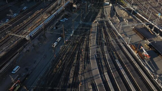 Aerial view showcasing Sunnyside Yard's expansive railroad networks, maintenance vehicles, and transportation infrastructure across Queens urban landscape