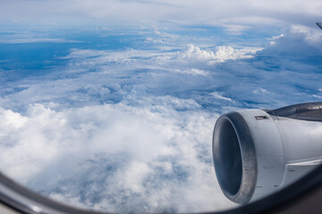 Beautiful sky seen from the plane window. Airplane hovering above the clouds