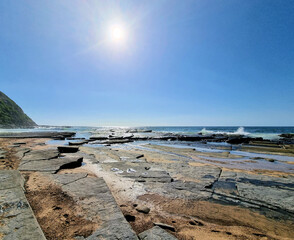 Rock platform at Susan Gilmore Beach Newcastle, New South Wales, Australia. At low tide with waves...