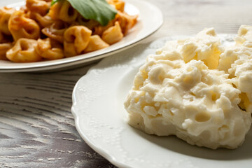 Tortellini with tomato sauce on a white plate