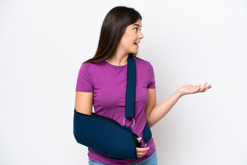 Young Brazilian woman with broken arm and wearing a sling isolated on white background with...