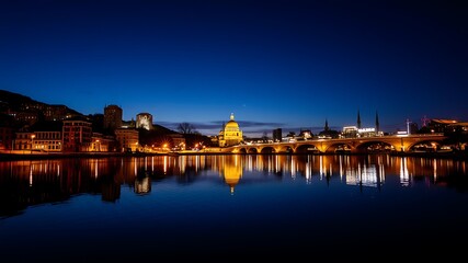 Nighttime cityscape of linz, austria, showcasing the illuminated danube river, pöstlingberg church, and the city's architecture reflected in the calm waters.