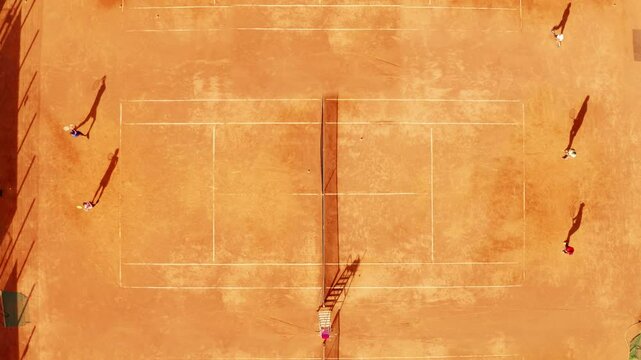 Competitive tennis match on clay court showcasing players in action during bright afternoon light in a vibrant outdoor setting