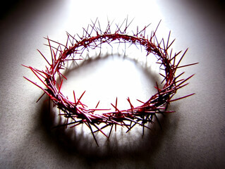 Fototapeta premium Crown of Thorns Rests on a Textured Surface, Illuminated Dramatically with Dark Edges