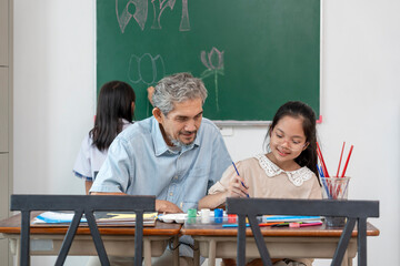 teen girls enjoy drawing watercolors with a senior experienced teacher,elementary students learning new skill of art during school break