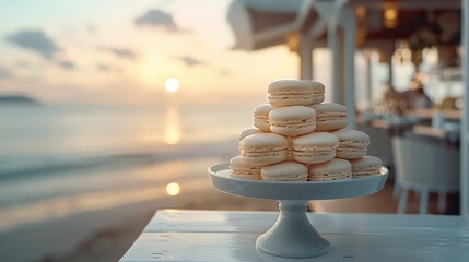 A pastry chef artfully arranges delicate macarons on a elegant cake stand, with a stunning beachside view and a stylish kitchen in the background