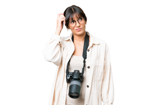 Young photographer caucasian woman over isolated chroma key background having doubts and with confuse face expression