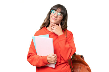 Young student caucasian woman over isolated background looking up while smiling