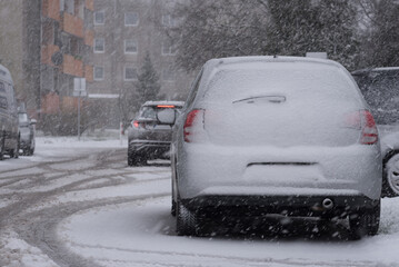 SNOWSTORM IN THE CITY - Vehicles and street are covered with a layer of snow