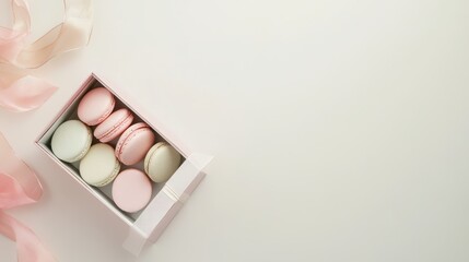 Colorful french macaroons in gift box on color background. Top view of various assorted flavors of classic French macarons in a gift box,almond cookies,Valentine's day sweet gift,holiday,celebration.