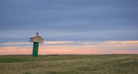 Mountain sign at sunset on a cloudy day