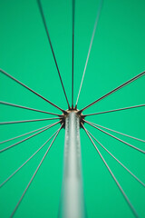 Fototapeta premium Bicycle Wheel Spokes Close-Up with Green Background