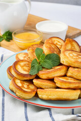 Cornmeal pancakes. Delicious golden pancakes with a mint leaf for breakfast. Close.