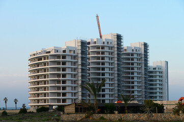 Fototapeta premium Modern residential building under construction near the coast at sunset