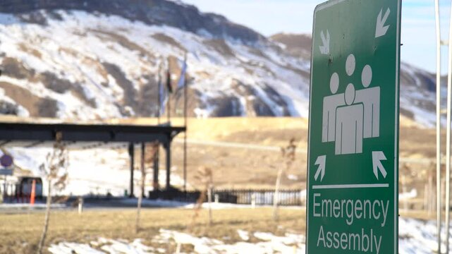 Green and white sign indicating the ASSEMBLY POINT in case of fire and emergency