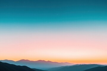 Fototapeta premium Colorful sunset illuminating mountain range with stars in the sky