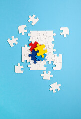 Autism Awareness Day, World Autism Day, April 2. Colorful and White Puzzles on Blue Background