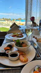 Sushi Rolls, Calamari, and a Glass of Champagne. Expensive Seafood Dinner in a Restaurant, Amateur...