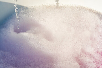 Fluffy White Soap Foam Floating in a Jacuzzi Under Sunlight, Perfect for Spa, Wellness, and Relaxation-Themed Concepts in a Natural Setting