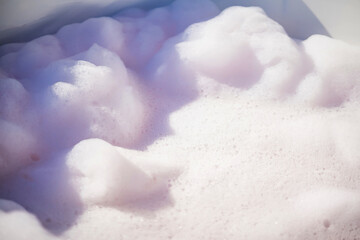 Fluffy White Soap Foam Floating in a Jacuzzi Under Sunlight, Perfect for Spa, Wellness, and Relaxation-Themed Concepts in a Natural Setting