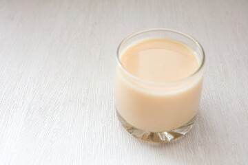 Glass of milk on white background