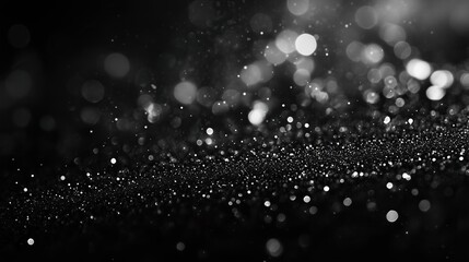 a bokeh of white snow on a black background