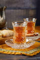 Azerbaijani black tea in armudu tea glass. Atmosphere of Baku and Eastern traditions. Oriental cuisine. Cozy atmosphere in the caucasus cafe.