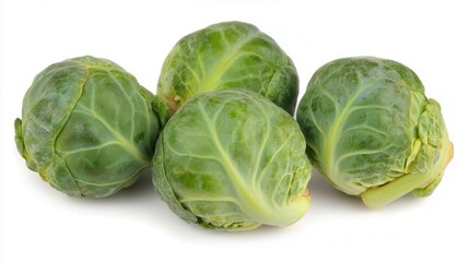 Fototapeta premium A detailed close-up showcasing three vibrant Brussels sprouts arranged on a clean white surface, emphasizing their texture and color.