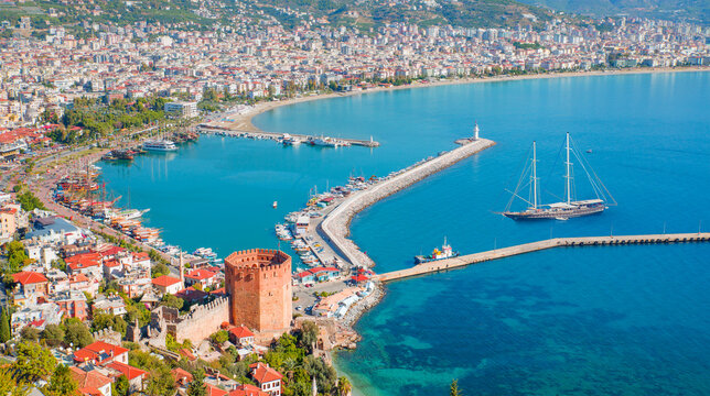 Ariel view of Alanya harbor from Alanya peninsula,  Black gulet anchored at the Mediterranean sea - Alanya, Antalya