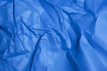 Sheet of crumpled blue paper as background, top view