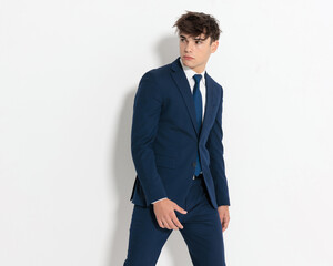 seductive businessman standing with parted legs and looking to side