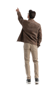 back view of smart casual man pointing in the distance