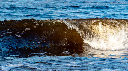 beautiful waves crashing against the seashore, windy day on the rocky shore of Vidzeme, Baltic Sea