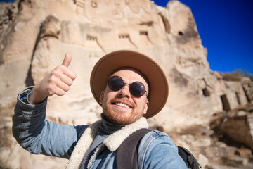 Young caucasian male exploring Cappadocia's ancient rock structures