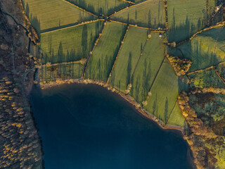 Dramatic aerial drone landscape in Autumn Winter of snowcapped mountains around Buttermere in Lake District at sunrise