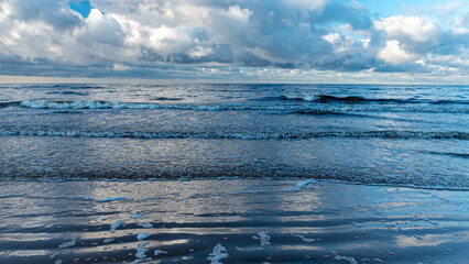 winter landscape with the seashore, backlight, windy winter day, dark cumulus clouds, Baltic Sea, Latvia